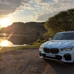BMW X5 parked near a beach